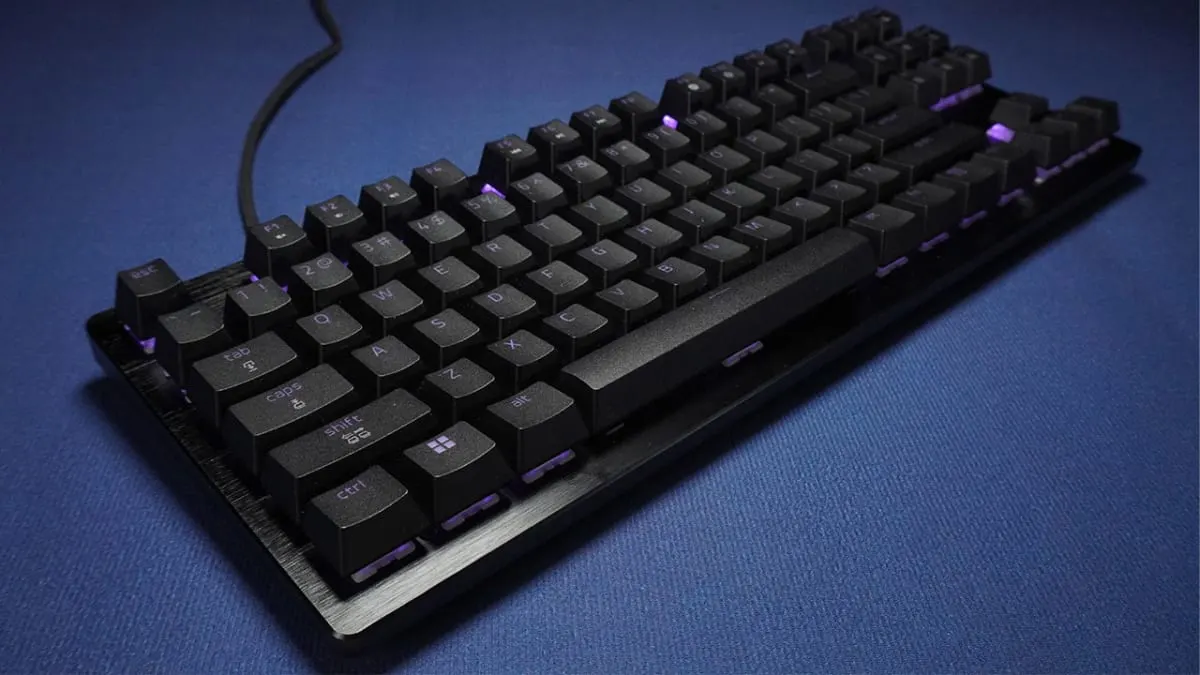 The Razer Huntsman V3 HE Magnetic TKL wired gaming keyboard photographed at an angle on a blue surface.